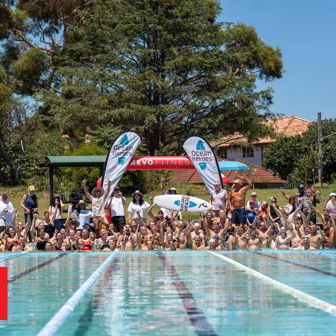 a group of people swimming in a pool of water