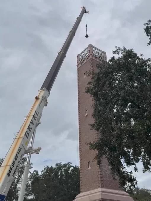 A crane extends toward Hulley Tower under a cloudy sky.