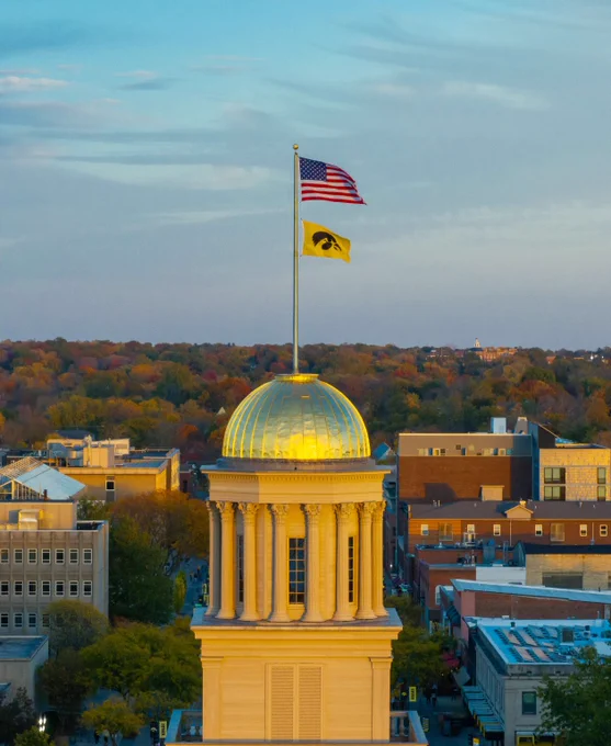 Photo of the Old Capitol Building flying an American flag and a Tigerhawk flag.