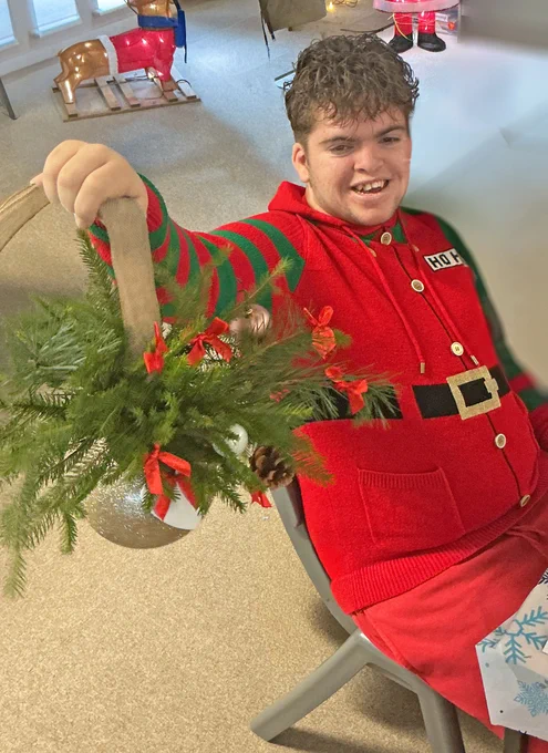 student holding a christmas bauble decoration