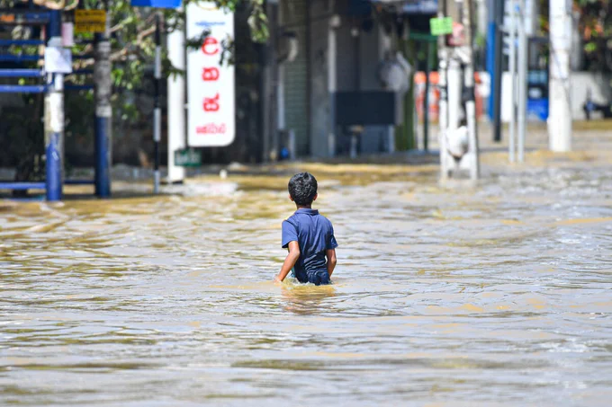 A young child walks through floodwaters after heavy rains from Cyclone Ditwah cause widespread flooding in Sri Lanka on November 30, 2025. Photo: Krishan Kariyawasam/NurPhoto v