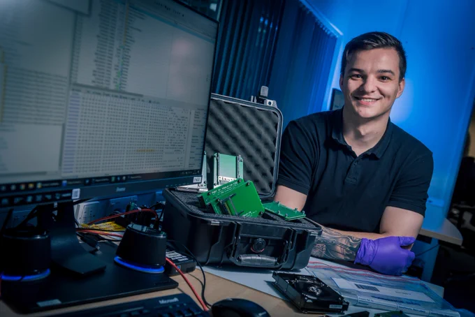 A man sits with equipment