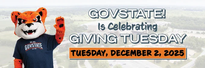 GovState mascot, a Jaguar, celebrates Giving Tuesday on December 2, 2025, with a banner and an aerial view of campus in the background.
