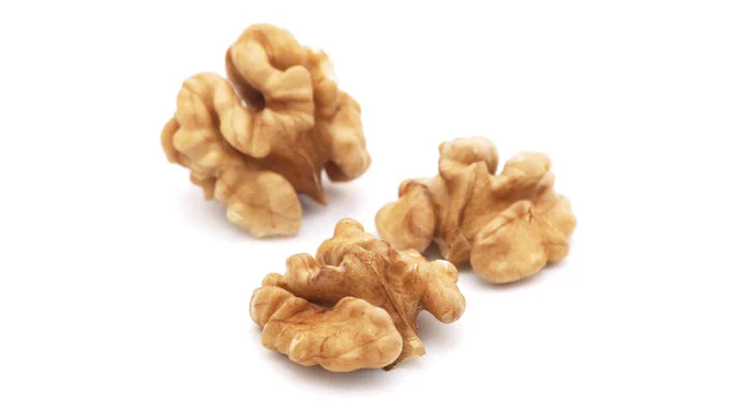 The image shows three walnuts.  