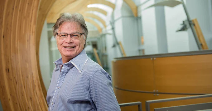 Dr. Terry Snutch is pictured, smiling, overlooking the atrium at the Michael Smith Labs building.