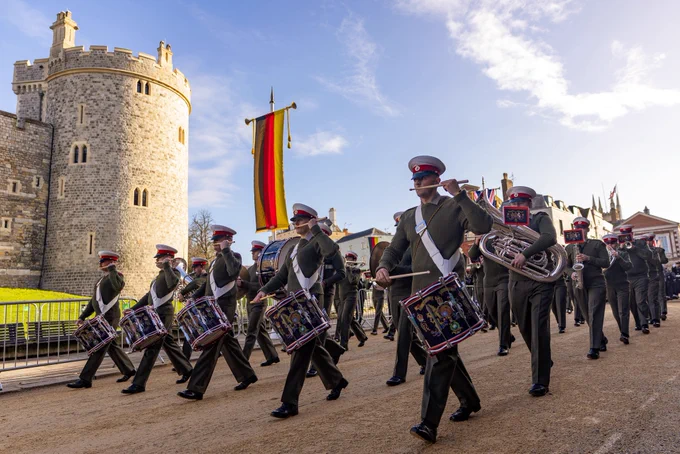 The Band of His Majesty’s Royal Marines marches through and play through Windsor beneath a German flag as they rehearse for the State Visit of Germany