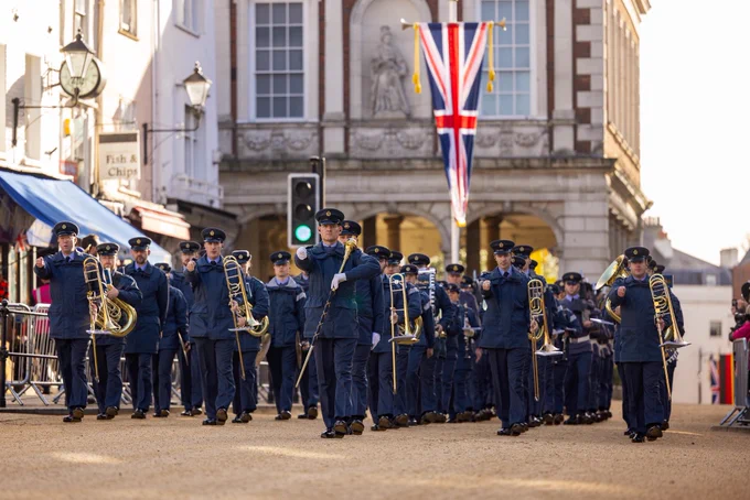 The Band of the Royal Air Force marches through Windsor in rehearsals for the German State Visit beneath a union flag