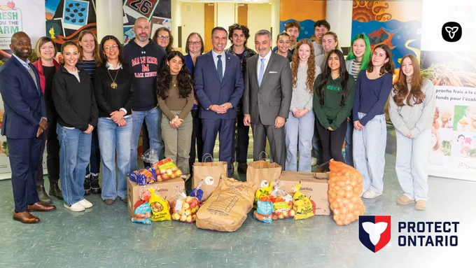 Minister Trevor Jones and Minister Paul Calandra with Malvern Collegiate Institute Principal and students, representatives from OFVGA and Fresh from the farm volunteers. There is the protect Ontario logo in the bottom right corner and the Ontario logo in the top right.