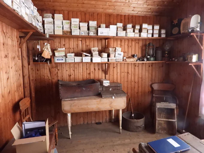 A photograph of the interior of the shop. It's a time capsule space full of original boxes and tools. 