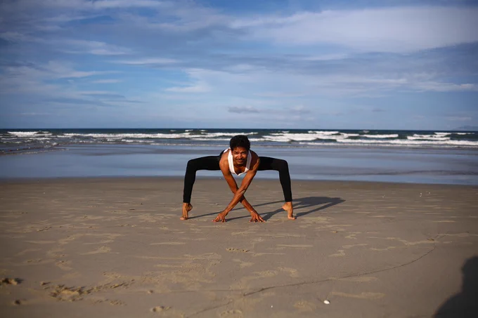 Person on beach doing yoga