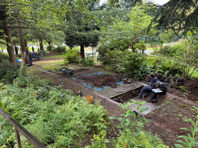 A trench cut in a wooded area in Kelvingrove Park.