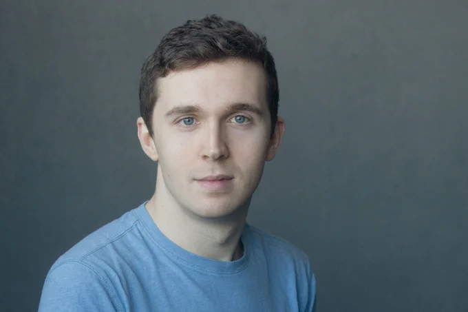 A photo showing a man in a t shirt 