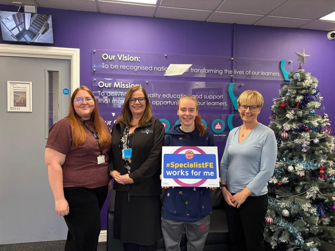Clare Howard with students and staff at Landmarks Specialist College. One of the students is holding a pledge board saying  Specialist FE works for me