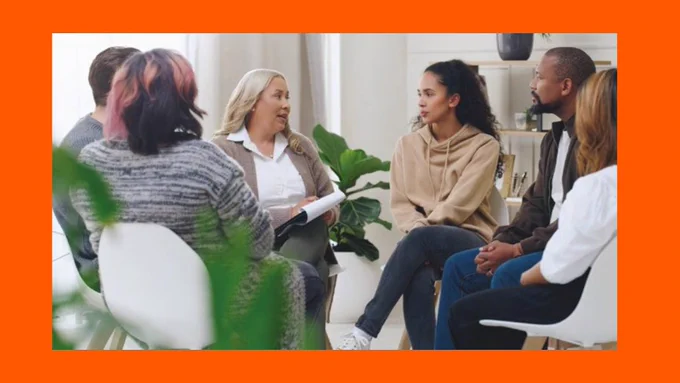 Orange background for an image showing a group of six women and men sitting together in a circle discussion. 