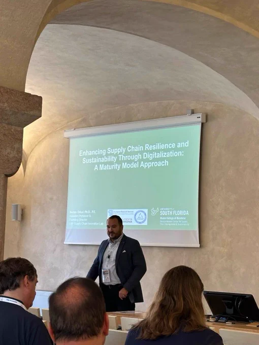 Seckin Ozkul giving a presentation on supply chain in Italy.