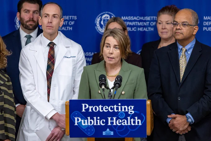 Governor Healey at “Protecting Public Health” podium sign.