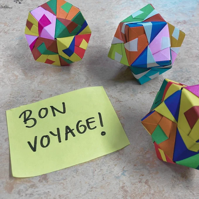Orgami ornaments with post-it note reading "Bon Voyage"