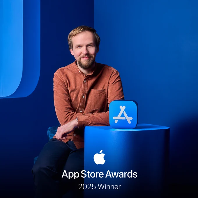 Me in a brown shirt leaning on blue column with the App Store Award sitting atop. A text on the image reads "App Store Awards 2025 Winner" with an Apple logo. 