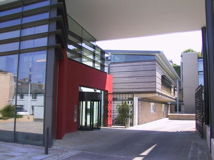 A glass and red building 
