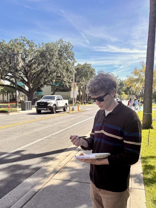 Weiksnar gathering traffic data on a busy road in Gainesville, Florida