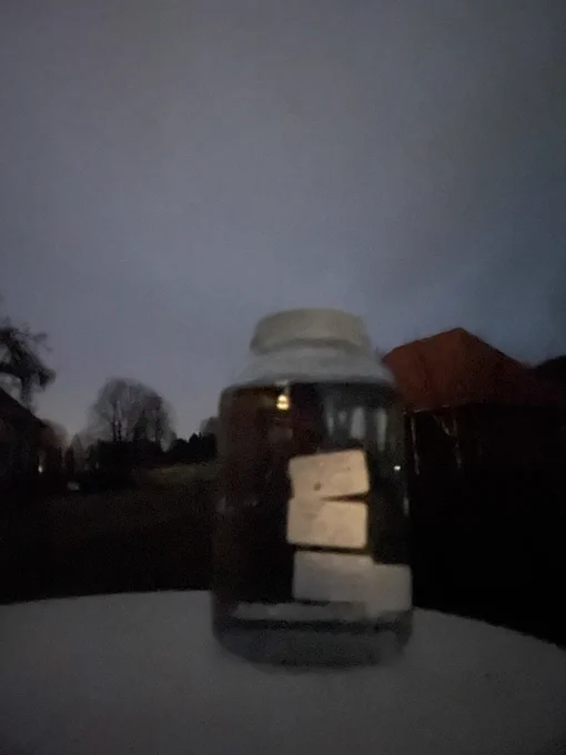 the triple super moon water in a large glass jar under the bright night sky