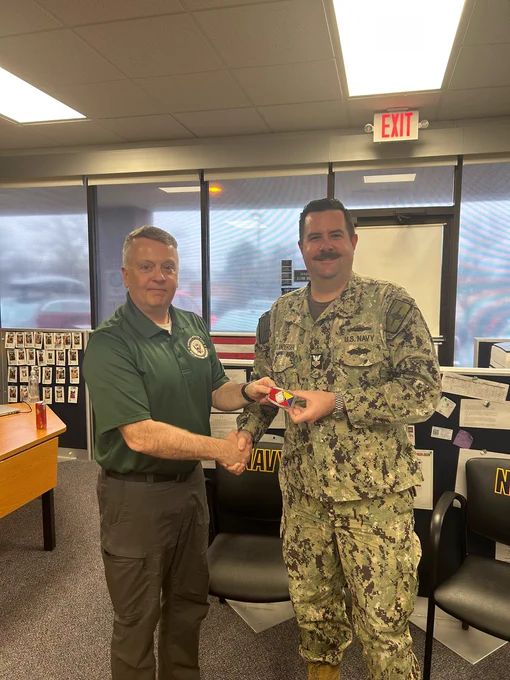 Rear Adm. James Waters, Commander, Navy Recruiting Command, visited Navy Recruiting Station Fredericksburg on Dec. 2 and presented Steelworker 1st Class Kastlandersen with a Navy Recruiting Command belt buckle for excellence and dedication to the mission.