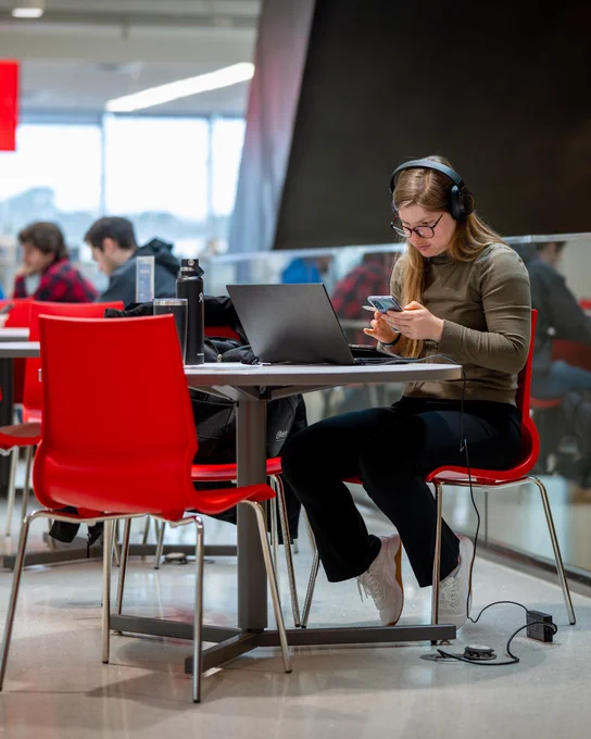 A student works at a table in Fitts-Woolard Hall.