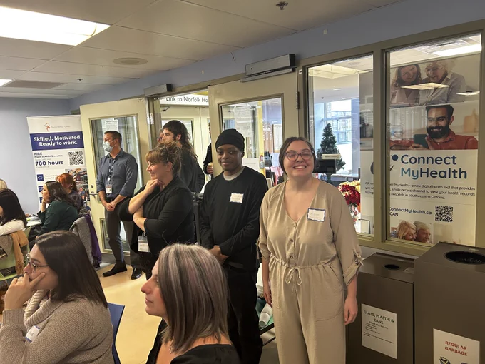 Two Project SEARCH Interns stand amid the excitement of the Simcoe and District Chamber of Commerce's Creative Workforce Solutions Symposium & Business After 5