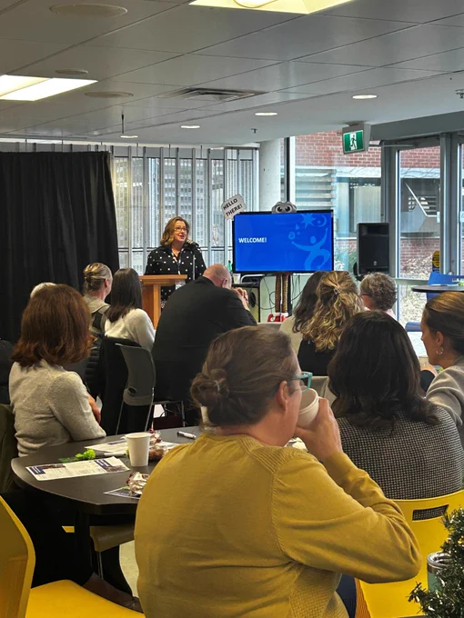 A woman speaks at a podium at the Simcoe and District Chamber of Commerce's Creative Workforce Solutions Symposium & Business After 5