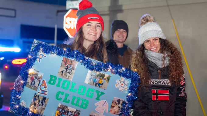 Two female students from the HSU Biology Club at the 2025 Arkadelphia Christmas Parade. 