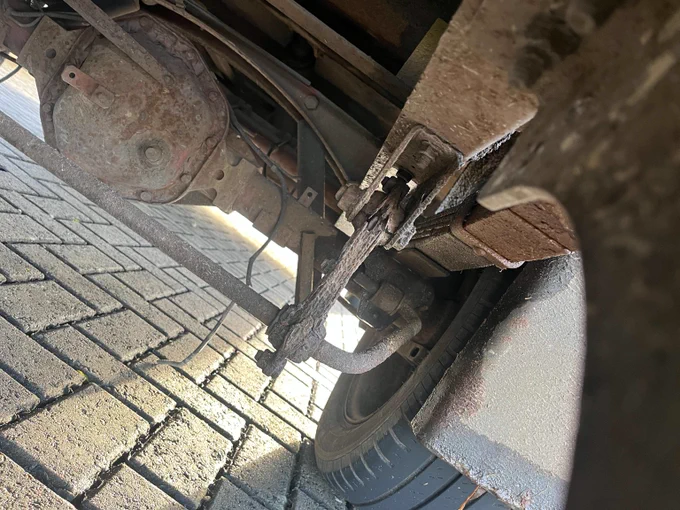 Light goods commercial vehicle with many road safety concerns including: Both rear anti-roll bar links were ready to break due to corrosion, Fuel tank strap missing, Badly corroded chassis cross member, Rear spring bushes badly worn out