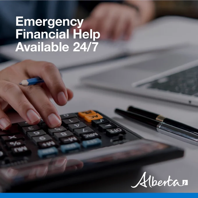 A photo of someone using a calculator, notebook and laptop. Text in the top left reads "Emergency Financial Help Available 24/7." The Government of Alberta logo is in the bottom right.