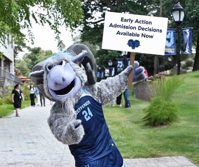 Phil the Ram holding a sign saying, "Early Action Admission Decisions Available Now"