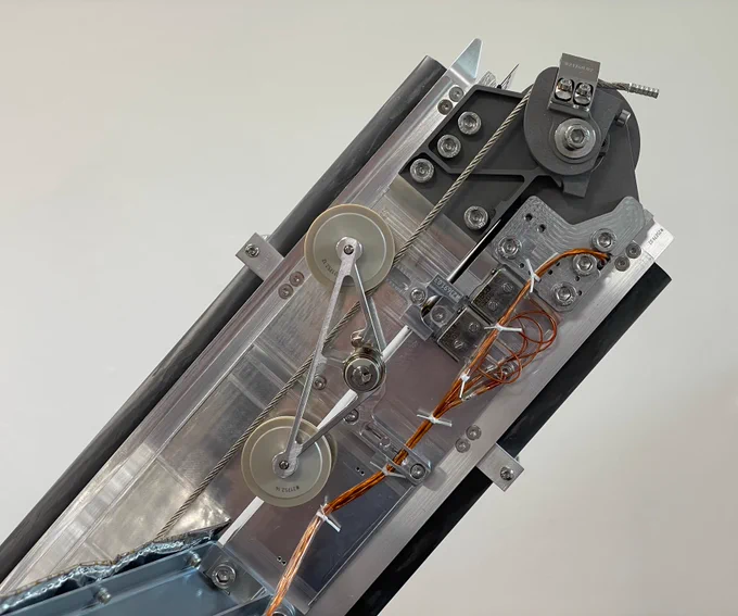 This close-up image shows a part of the mechanism that will swing the ramps open on the Red Planet. 