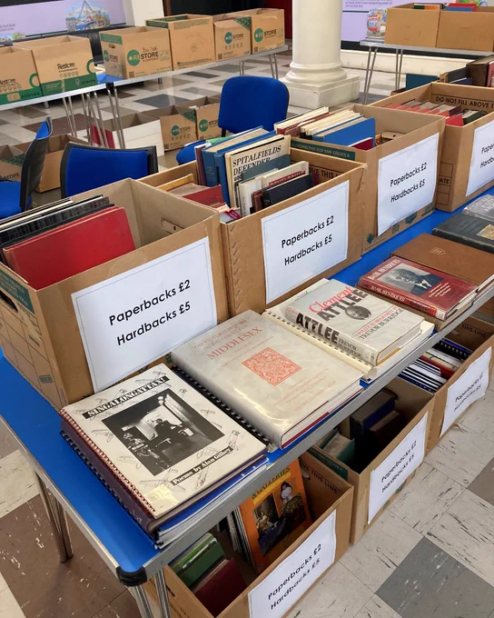 Boxes filled with books on a table.