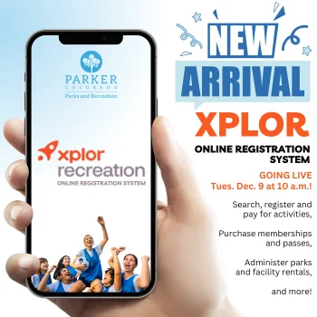 An image of a hand holding a mobile phone with information on the new Xplor online registration system . 