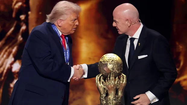 PHOTO: Donald Trump celebrates 'great honour' of winning FIFA peace prize, shaking hands with FIFA President Gianni Infantino, with cup in foreground