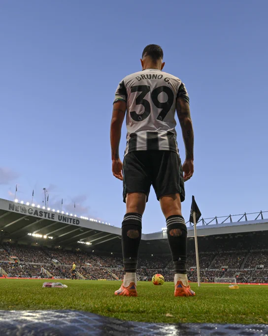 Bruno Guimarães standing over the ball ready to take a corner