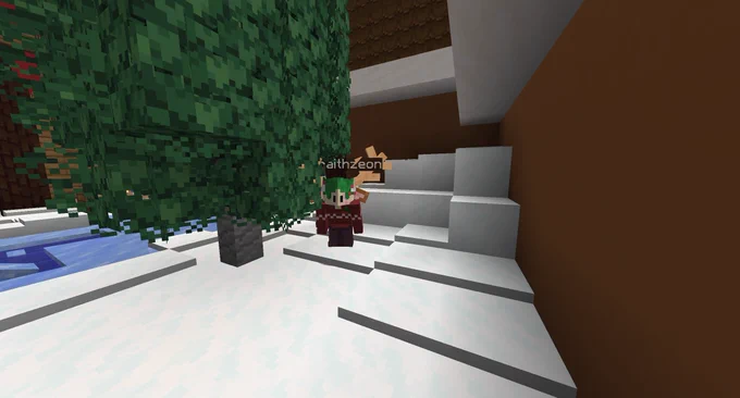 A Minecraft character with green hair, antlers, and a red winter sweater stands beside a snowy staircase next to a Christmas tree.