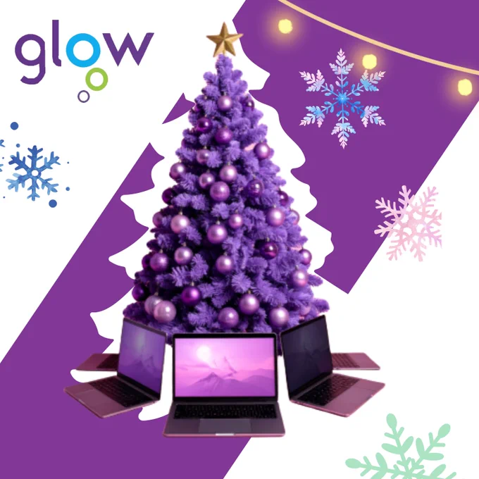 The image shows a Christmas tree and laptops are placed around the foot of the tree.