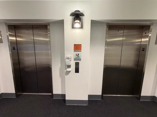 An entry way with two elevator doors side by side