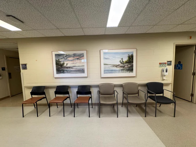 Two beautiful paintings by Shirley Maklik depicting rocky and treed shorelines on lakes bring to life a waiting area at the Orillia Soldiers' Memorial Hospital (OSMH).