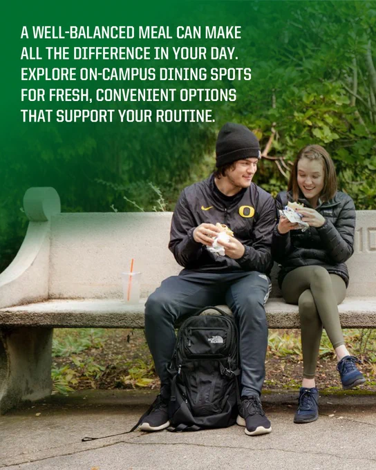 Two people sitting on a bench enjoying a meal outside, with a backpack featuring the University of Oregon logo beside them. The background shows lush greenery. Text overlay promotes the benefits of well-balanced campus meals.