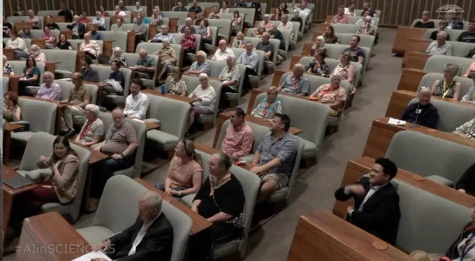 A crowd sits in an amphitheater. 
