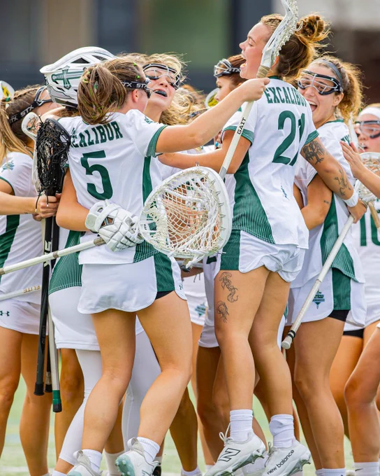 Action photo of the Trent Excalibur women's lacrosse team celebrating a win at the OUA Championship 