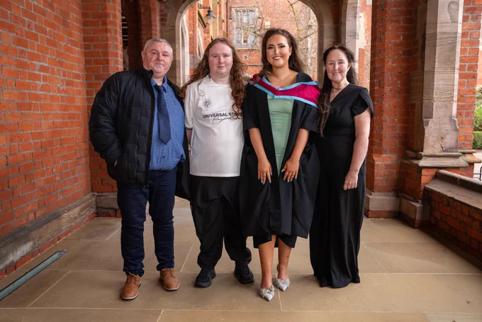 Image shows Tanisha pictured with her dad, brother Corey and her mum (L-R). They are pictured in the Cloisters at Queen's and Tanisha is wearing her graduation gown.
