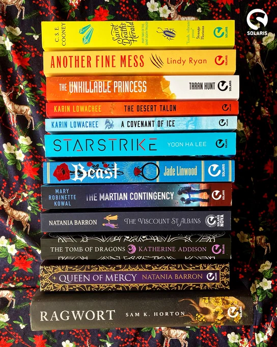 A stack of Solaris sequels against mid blue fabric with a festive pattern. 

Featured in the stack:
SAINT DEATH'S HERALD (SAINT DEATH'S DAUGHTER 2) by C. S. E. Cooney
ANOTHER FINE MESS (BLESS YOUR HEART 2) by Lindy Ryan
THE UNKILLABLE PRINCESS (KYSTROM CHRONICLES 2) by Taran Hunt
THE DESERT TALON & A COVENANT OF ICE (THE CROWNS OF ISHA 2 & 3) by Karin Lowachee
STARSTRIKE (LANCERS 2) by Yoon Ha Lee
BEAST (CHARMING 2) by Jade Linwood
THE MARTIAN CONTINGENCY (LADY ASTRONAUT 4) by Mary Robinette Kowal
THE VISCOUNT ST ALBANS (NETHERFORD IN LOVE 2) by Natania Barron
THE TOMB OF DRAGONS (THE CEMETERIES OF AMALO #3) by Katherine Addison
QUEEN OF MERCY (QUEENS OF FATE 3) by Natania Barron
RAGWORT (THE EYTHIN LEGACY 2) by Sam K. Horton
