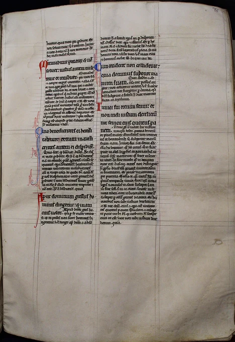 Two columns of text with alternating red and blue capital letters. The text is in two fonts. Capital letters have tails or flourishes extending downwards generally. This copy was made in England.