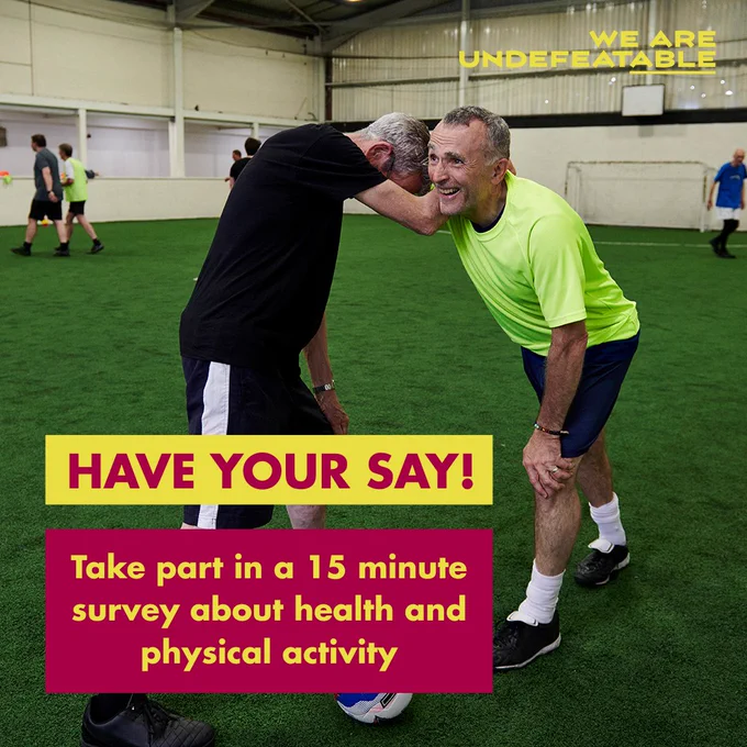 Two men embracing on an indoor football field, with text that reads, Have your say! Take part in a 15 minute survey about health and physical activity. With the We Are Undefeatable logo in the top corner. 