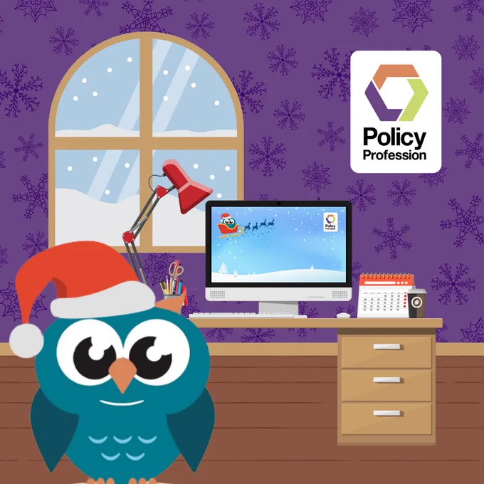 Cartoon owl wearing a Santa hat in a cozy room with a snowy window and a computer displaying a festive winter scene.